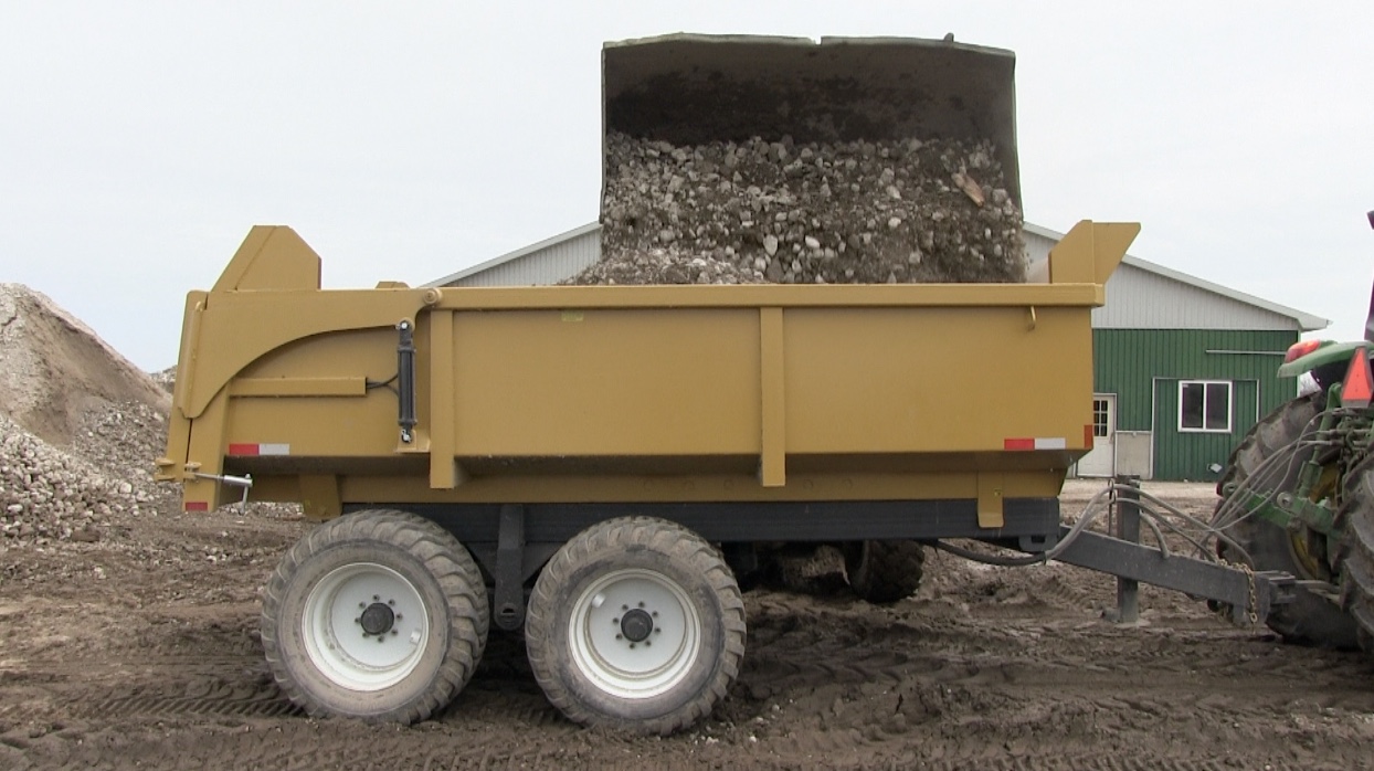 The 16 ton heavy duty dumper trailer getting loaded with dirt and gravel