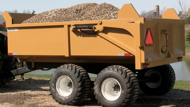 A close-up image of the 12 ton off-road dumper trailer full of mulch
