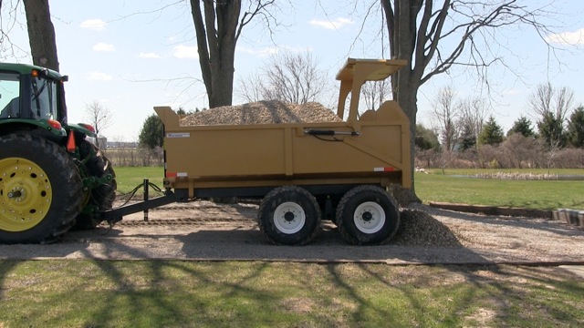 A close-up image of the 12 ton off-road dump trailer full of mulch
