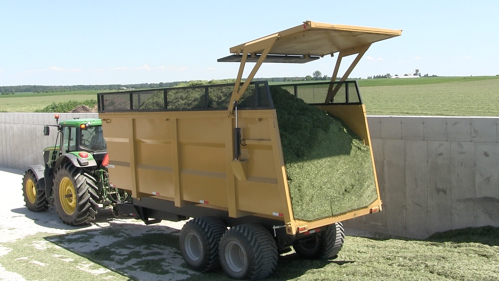 A backshot of the 20 ton silage dump trailer holding hay silage