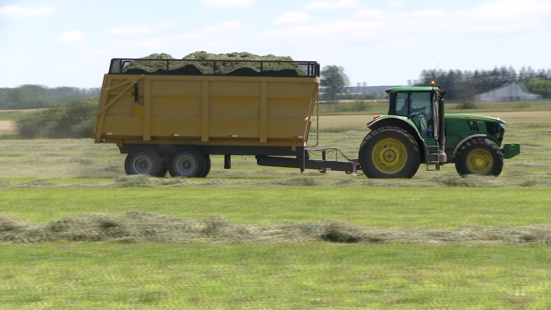A side shot of the 20 ton dumper trailer being hauled by a tractor